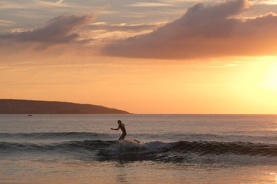 Surfer at Sunset off the Cornish Coast 