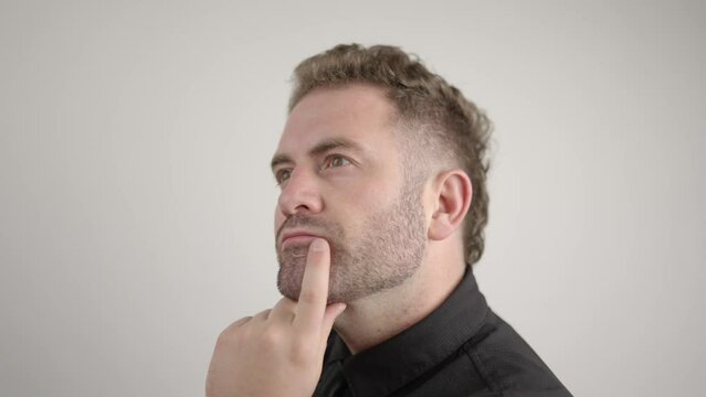 man thinking with hand on chin