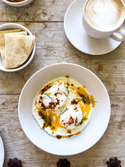 Turkish Eggs, also known Çılbır is a Turkish dish of poached eggs with yogurt, garlic, and Aleppo pepper melted with butter