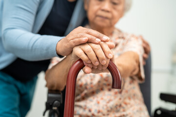 Caregiver help Asian elderly woman patient with love, care, encourage and empathy at nursing...