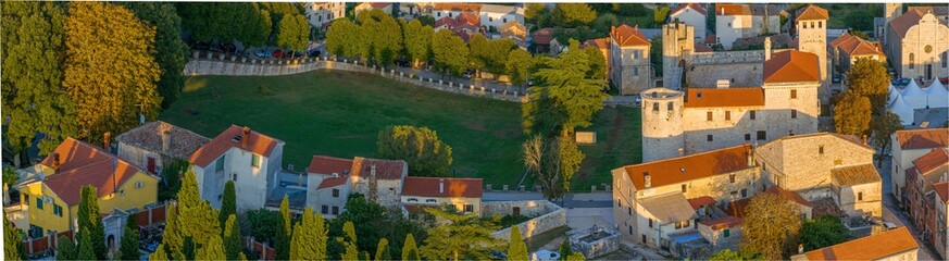 Drone panorama of the Istrian village of Svetvincenat with medieval castle in evening light