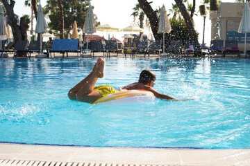 Child enjoying a refreshing pool day, creating dynamic water splashes with a colorful float