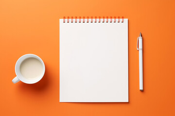 Blank notepad white pen and cup of milk coffee latte on minimal orange background top view. Office stationary concept - obrazy, fototapety, plakaty