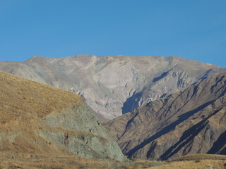 paisaje con cielo celeste casi azul, prístino, limpio sin nubes con un gran contraste con las montañas