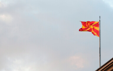 The national flag of North Macedonia waving in the wind in Skopje