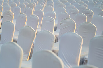 rows of white seats in sunset