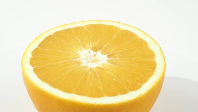 Ripe oranges rotate on a white background. Oranges close-up on white.