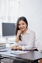 Asian Business woman using calculator and laptop for doing math finance on an office desk, tax, report, accounting, statistics, and analytical research concept
