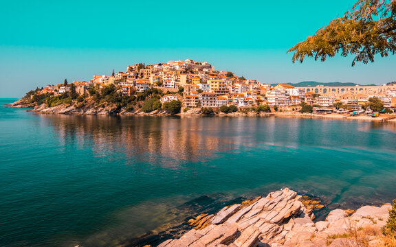 Scenic view of Kavala city in northern Greece with colorful houses, clear Aegean waters, and historic architecture along the coastline