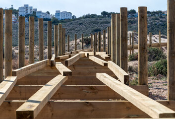 Elevated boardwalk under construction in the Carabassi beach, province of Alicante, Spain