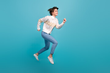 Full body length photo of running person attractive young lady flying jump trampoline workaholic isolated over blue color background