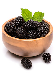 Fresh and ripe blackberries in a wooden bowl on white background 