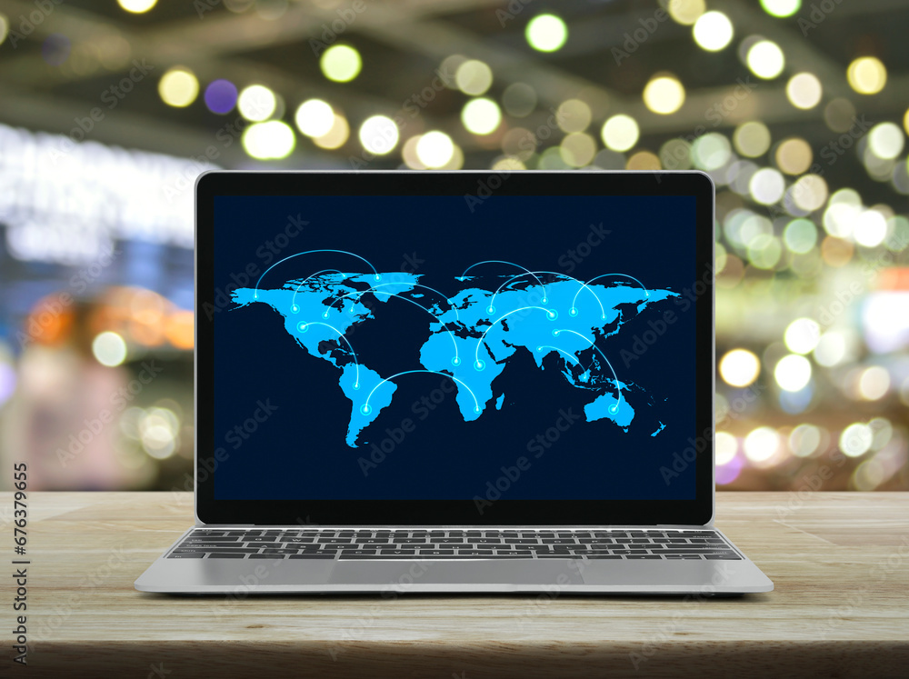 Poster connection line with global world map on laptop computer monitor screen on wooden table over blur of
