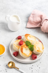 Cottage cheese fritters or syrniki served with honey.
