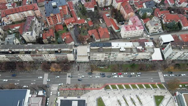 Aerial view of a street in residential area of the town Leskovac in southern Serbia while snowflakes fall slowly