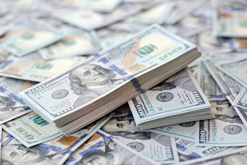 Very big amount of US hundred dollar bills close up. Huge quantity of united states currency notes on flat table