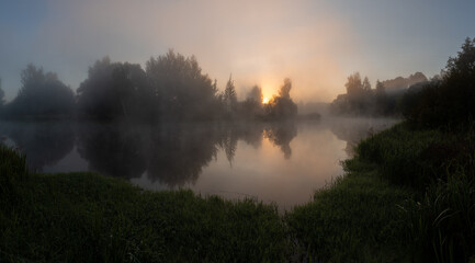 Dawn over a foggy river