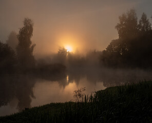 Dawn over a foggy river