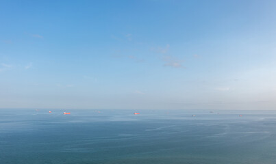 Obraz premium A group of cargo ship vessels in the Baltic sea waiting to enter the port of Skagen, Denmark. Aerial landscape.