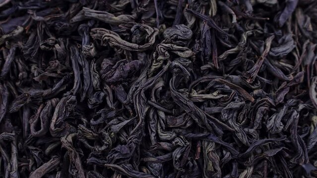 Dried black ted leaves texture circle rotation close up top view