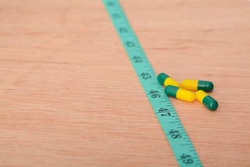 the combination of slimming pills and measuring tape, providing individuals with effective tools to support their dietary choices