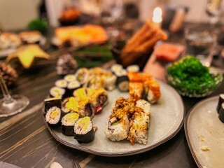 a dish on a festively decorated table with japanese sushi rolls with raw fish