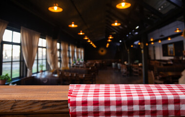 Empty wood table top and blur of cafe restaurant in dark night background. High quality photo