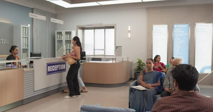 Establishing Shot of Indian Patients Waiting in Reception Hall in a Hospital. Active Local Health Clinic Lobby During the Day, Representing Modern and Advanced Healthcare Service 