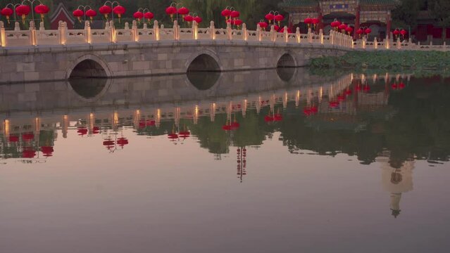 Sunset at Beihai Park decorated with traditional Chinese Lantern and the Beijing White Pagoda Temple (Baita Si), also known as White Dagoba Temple or White Stupa Temple in the background, Beijing
