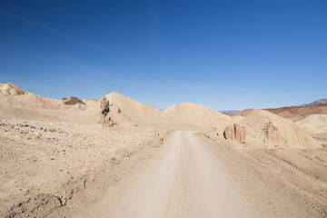 Fototapeta na wymiar Gravel road through Death Valley National Park, California