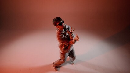 A man stands in the frame against a red background. The camera is slightly overhead. Demonstrates a...