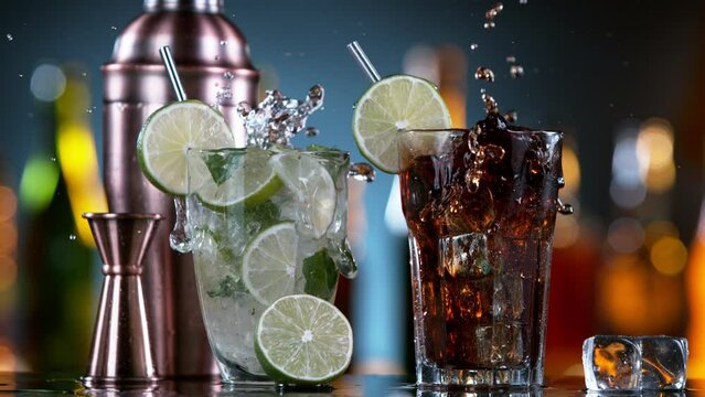 Super Slow Motion of Falling Ice Cube Into Mojito and Cuba Libre Drinks. Filmed on High Speed Cinema Camera, 1000 fps. Speed Ramp Effect.