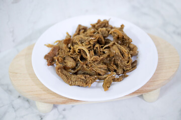 Fried snake cobra with raw chili sauce sambal matah. Extreme food cuisine on dish.