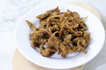 Fried snake cobra with raw chili sauce sambal matah. Extreme food cuisine on dish.