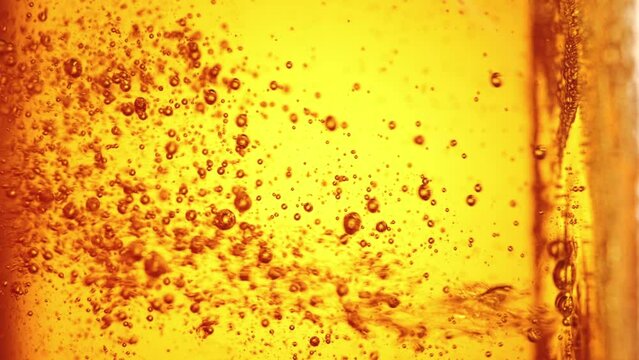 Close-up of beer pouring into glass. Lager foamy beer with bubbles rising upwards. Hop drink. Concept of beer drink, brewery, taste, bar, degustation, festival, drink texture. Vertical layout