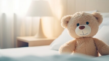 A teddy bear is sitting on a cozy bed