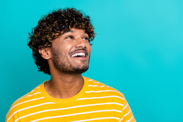 Photo portrait of handsome young guy look smiling empty space dressed stylish striped yellow outfit isolated on cyan color background