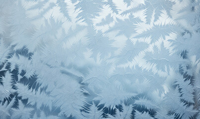 Frost patterns on frosted window pane in cold winter, abstract winter background with free space for text