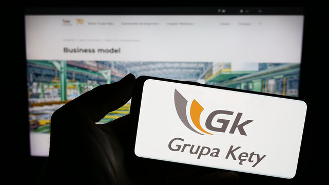 Stuttgart, Germany - 11-07-2023: Person holding smartphone with logo of Polish aluminium company Grupa Kety S.A. in front of website. Focus on phone display.