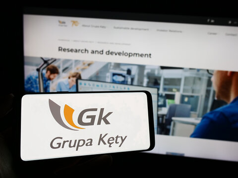 Stuttgart, Germany - 11-07-2023: Person holding mobile phone with logo of Polish aluminium company Grupa Kety SA in front of business web page. Focus on phone display.