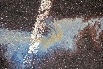 Foto op Aluminium Oil spill on wet asphalt, parking lot with dividing line © AleksFil