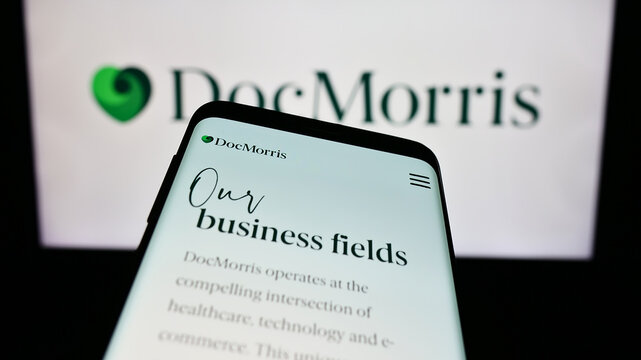 Stuttgart, Germany - 11-08-2023: Mobile phone with website of Swiss online pharmacy company DocMorris AG in front of business logo. Focus on top-left of phone display.