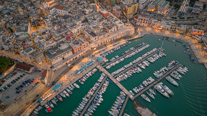 Aerial view of seafront and old town Bisceglie in Puglia with drone on sunset.