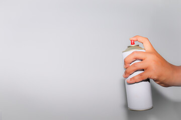 hand with white spray can