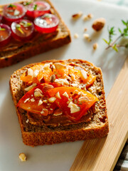 fruit sandwich with persimmons, on marble white board, yellow warm background, top view, close-up