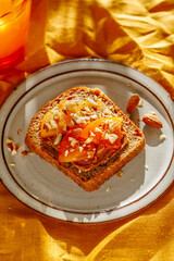 fruit sandwich with persimmons, on a ceramic plate, yellow warm background, sunlight, top view, close-up