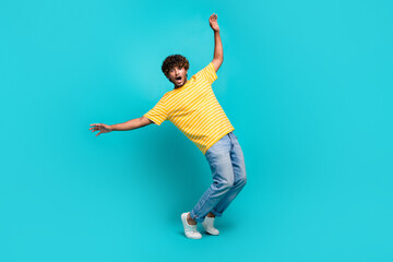 Fototapeta na wymiar Full size photo of handsome young guy frightened avoid falling dressed stylish striped yellow outfit isolated on cyan color background