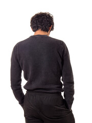 A man in a black sweater and black pants, seen from the back, unrecognizable, looking at something,...