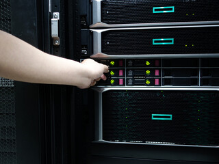 Man fixing server in data center room