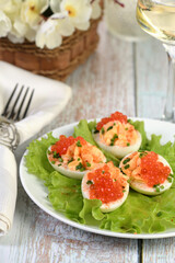 Stuffed eggs with salmon caviar are a popular appetizer for any occasion. Elegantly decorated and expertly seasoned, they will always be a beautiful appetizer at a party.